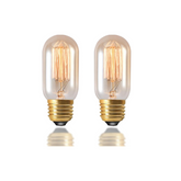 Two vintage-style light bulbs with clear glass and gold bases on a white background